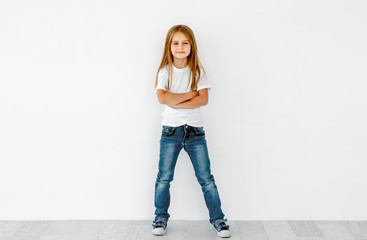 Cute little girl with crossed hands isolated on white