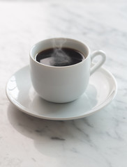 Hot cup of espresso coffee on a table