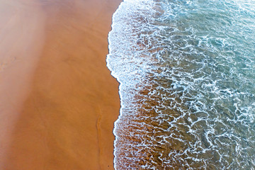 Aerial top shot from ocean waves at the beach