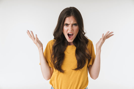Image of angry resentful woman wearing casual t-shirt screaming and raising hands