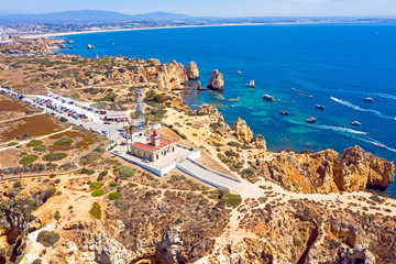 Aerial from natural rocks and the lighthouse at Ponte Piedade in Lagos Portugal