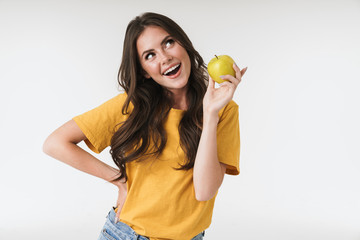 Photo of caucasian woman 20s wearing casual clothes smiling and holding green apple