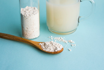 Diatomaceous earth also known as diatomite mixed in glass of water, good for human body detox concept.