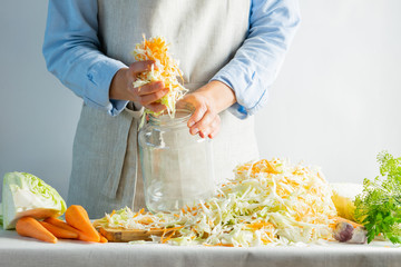 The preparation process fermentation preservation Sauerkraut on a light background. Natural rustic...