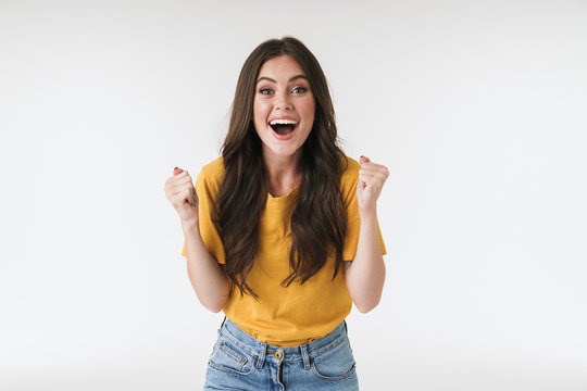 Image of astonished brunette woman wearing casual t-shirt screaming and rejoicing