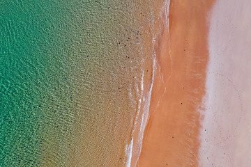 Aerial top shot from ocean waves at the beach