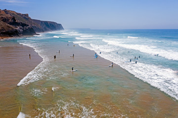 Aerial from surfers getting surfing lessons at the atlantic ocean