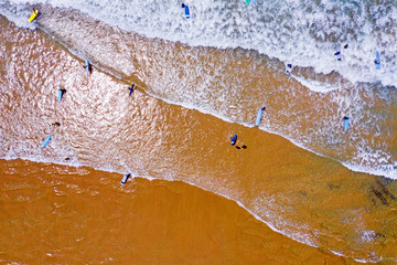 Top shot from surfers getting surfers lessons in the atlantic ocean