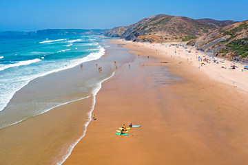 Aerial from surfers getting surfers lessons at Praia Vale Figueiras in Portugal