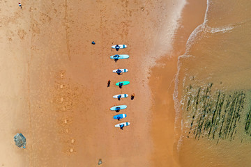 Aerial top shot from surfers getting surfers lessons at Praia Vale Figueiras in Portugal