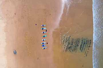Aerial top shot from surfers getting surfers lessons at Praia Vale Figueiras in Portugal