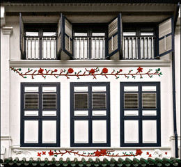 White peranakan house with blue wooden shutters