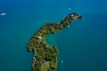Unique view of the island of Garda. In the background is the Alps. Resort place on Lake Garda north of Italy. Aerial photography.