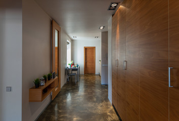 Entrance hall of modern studio apartment. Served table.