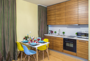 Modern interior of studio apartment. Ktchen set. Green curtains.