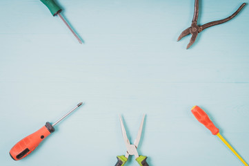 tools close-up top view, screwdriver, pliers, toning, vignetting