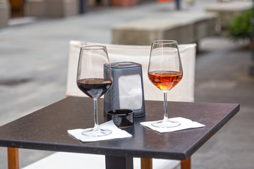 Outdoor two glass of wine on table outside the bar relaxing at holiday concept.