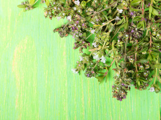 Thyme with flowers on old wooden background
