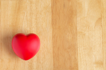  Red heart is placed on the wooden floor and copy space for design input text.Valentines Day concept.World Heart Day.