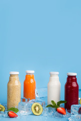 Different detox cocktails in glass bottles with fruits