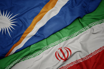 waving colorful flag of iran and national flag of Marshall Islands .