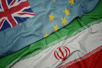 waving colorful flag of iran and national flag of Tuvalu .