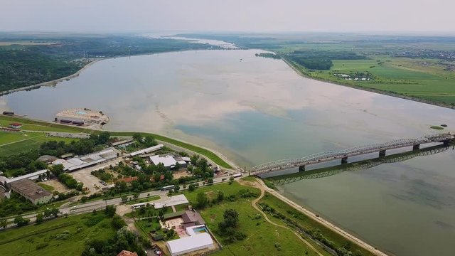 Aerial Drone Flight: View of the bridge over the river with cars. Olt river, Romania