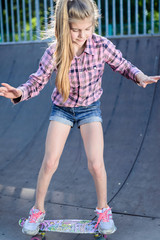 girl learns to skate on the skatepark