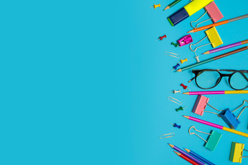 Stationary supplies placed on blue background, Back to school concept, Copy-space