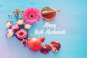 religion image of Rosh hashanah (jewish New Year holiday) concept. Traditional symbols over wooden blue background