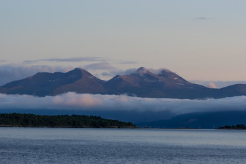 Fototapeta na wymiar Landscape of mountains coming out from the sea in Molde, a beautiful view from of the fjord.
