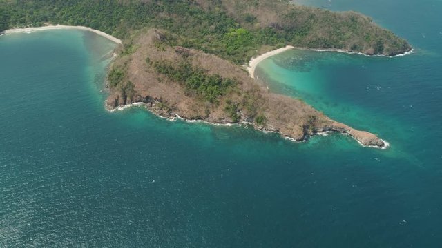 Aerial view coastline with tropical beach, island Limbones, lagoons and coral reefs. Neela cove, Philippines, Luzon. Coast ocean with turquoise water. Tropical landscape in Asia.