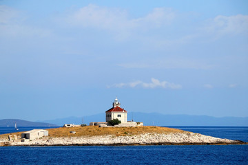 Picturesque lighthouse on a small island near town Hvar, on island Hvar, Croatia.