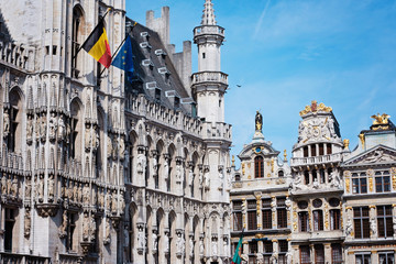 Grand place in Brussels with golden ornaments and blue sky