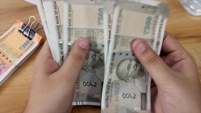 Accountant counts 500 rupees Indian currency  . 