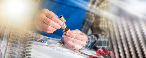 Plumber using plumbing fittings, light effect; multiple exposure