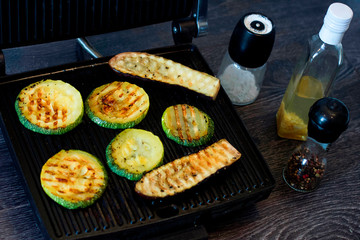 Zucchini sliced ​​rings and eggplant fried, grilled, vegetables cooked on grill. Salt, pepper and oil. Vegan or vegetarian food, meal.