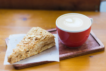 Cup of coffee and cake on a wooden table