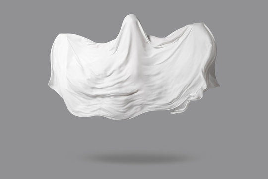 a Ghost in a white fabric fluttering in the wind on a gray background in the Studio. Halloween minimal concept.