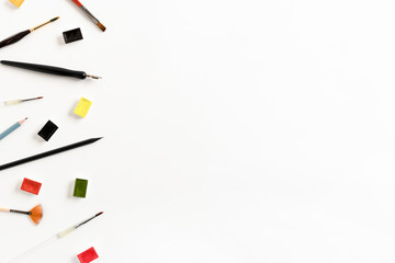 Border frame made of paint brushes and watercolor