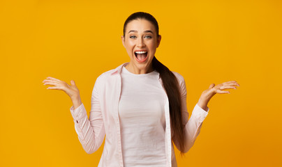 Happy Young Woman Shouting Celebrating Success Over Yellow Studio Background