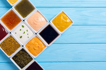 Set of different sauces in ceramic bowl