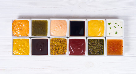 Set of different sauces in ceramic bowl