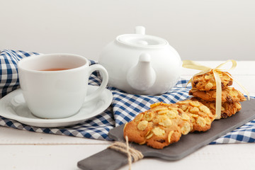 Fototapeta na wymiar Homemade crunchy cookies and tea on a wooden table
