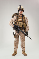 Portrait of a young American US Marine Corps soldier over grey background