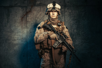 War, army, weapon concept. Private military contractor holding rifle