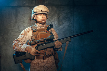 War, army, weapon concept. Private military contractor holding rifle