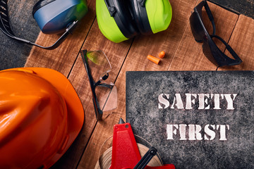 Safety first sign with personal protective equipment