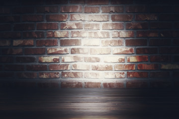 Empty scene background. Old brick wall, wooden floor. Spotlight in the dark