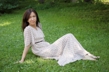 Cute young woman lying on the grass. Soft focus.